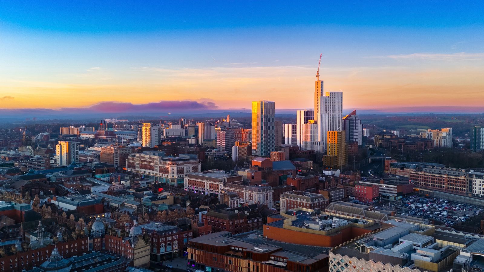 Aerial view of Leeds city centre skyline at sunset, including Bridgewater Place and the Corn Exchange