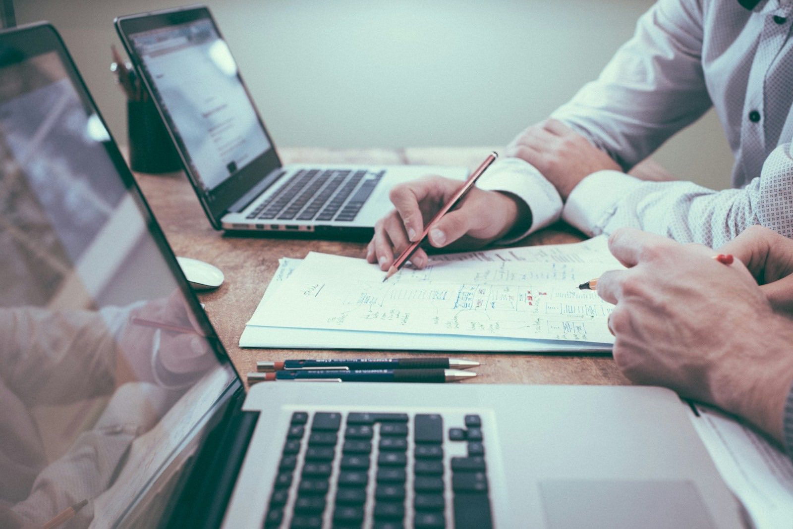 Advisers working through documents together at a desk